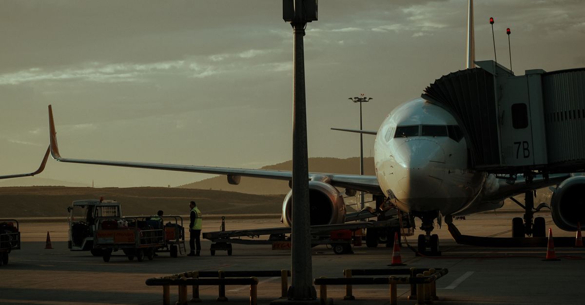 A commercial airplane on the tarmac at an airport.