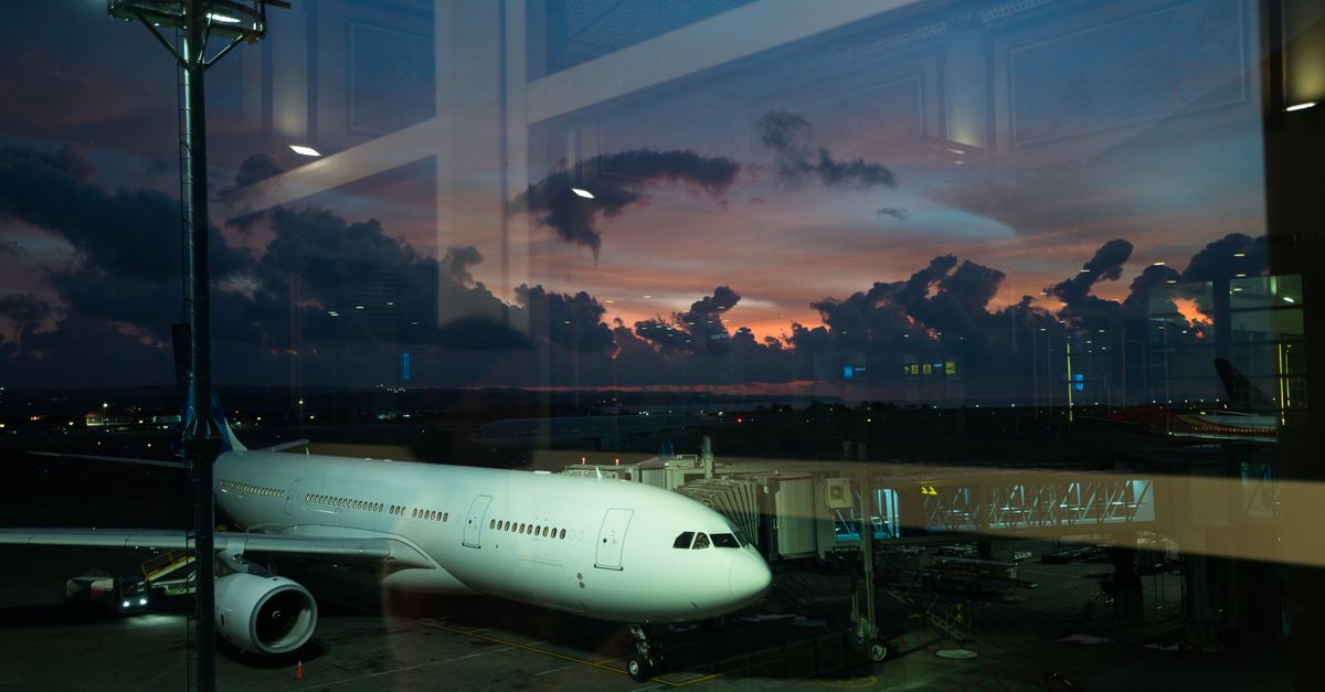 An airplane at an airport gate.