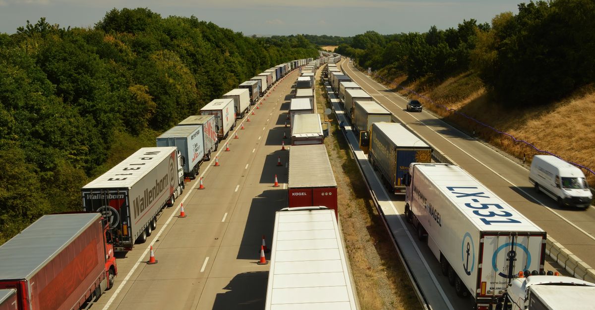 A line of trucks on a road, possibly in a traffic jam or queue.