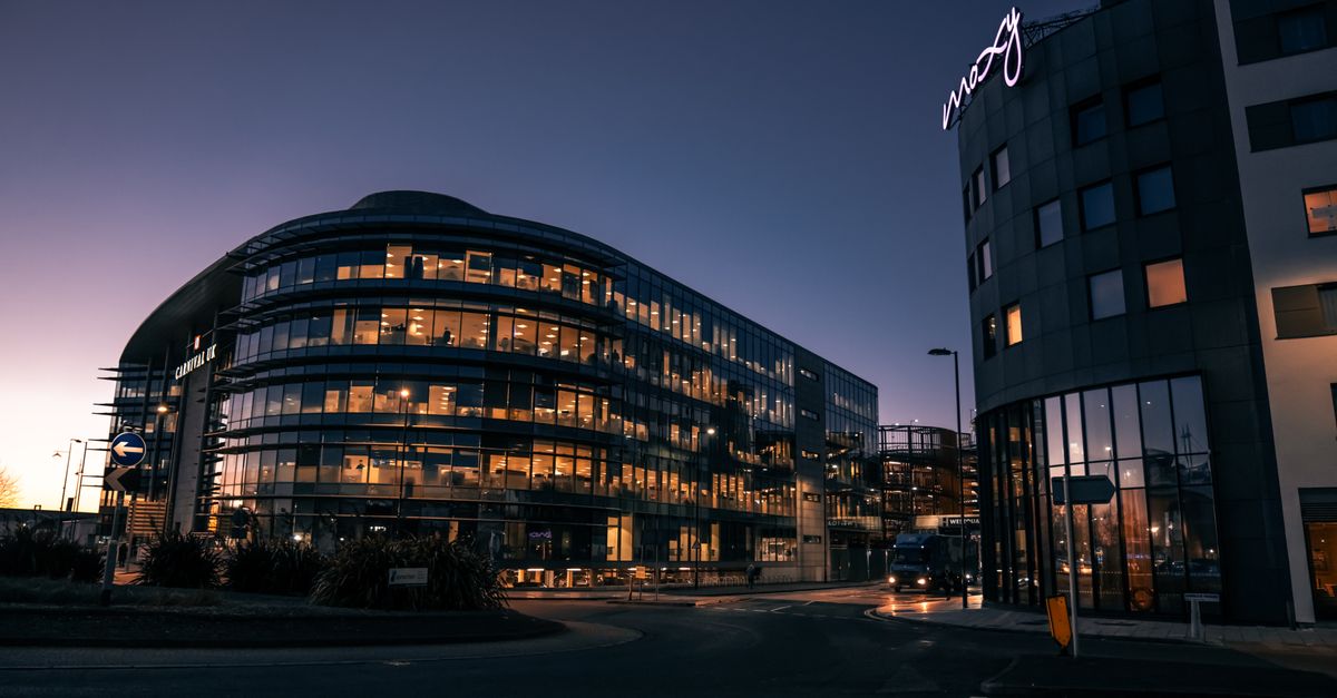 A sleek, modern office building illuminated at night in Southampton city center.