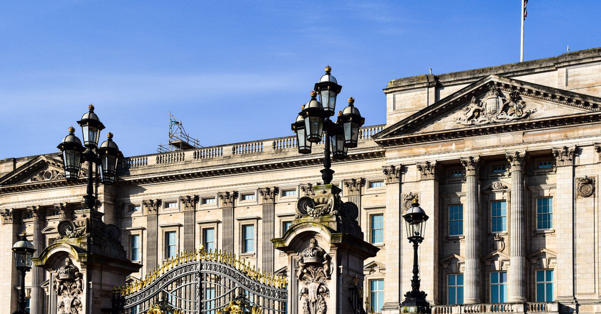 Exterior view of Buckingham Palace in London showcasing its historic architecture and ornate gate.