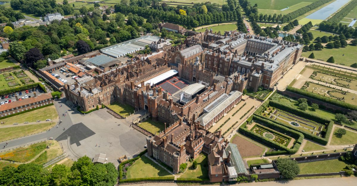Stunning aerial view of Hampton Court Palace in summer, showcasing historic architecture and gardens.