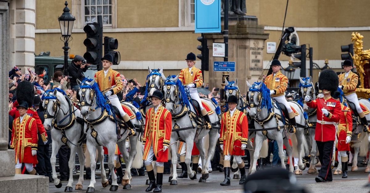 A majestic display of the royal guard parade through the streets of London with horses and traditional attire.
