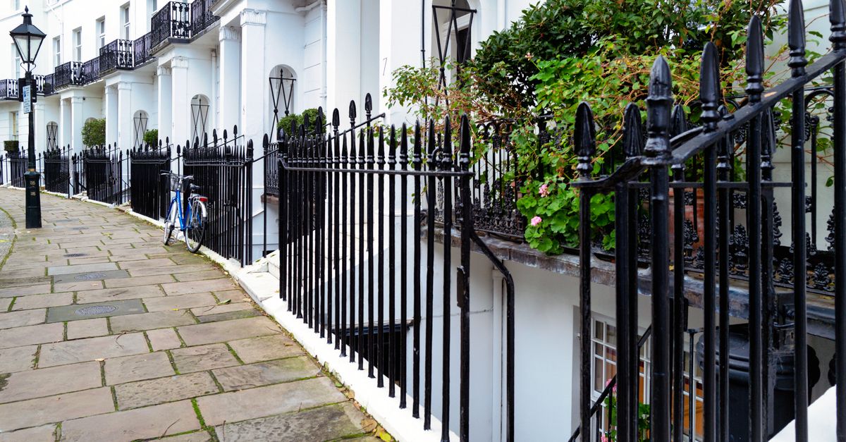 Stunning Georgian townhouses with classic ironwork in Kensington, London. Captured outdoors during the day.