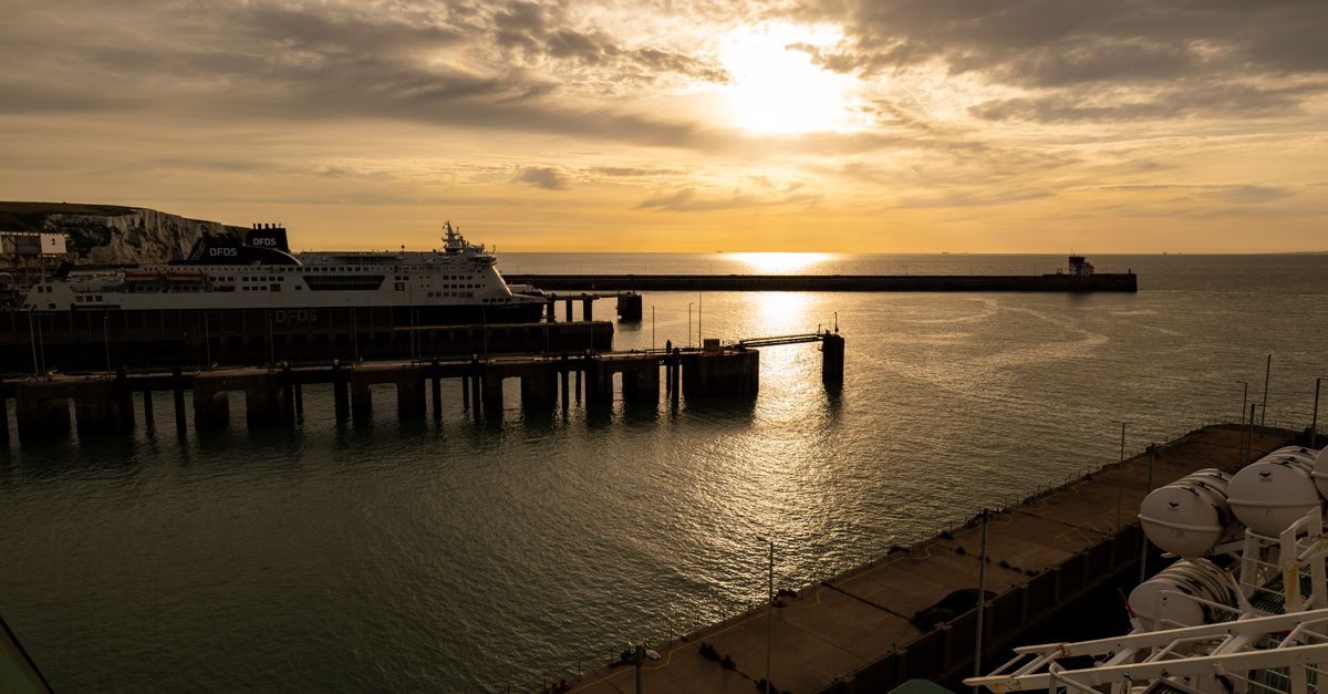 A serene sunset over Dover port with a ferry docked, capturing the peaceful maritime atmosphere.