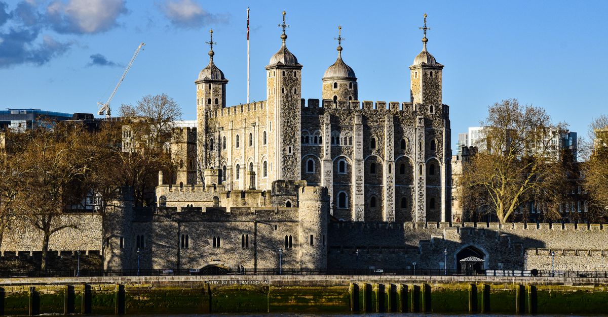 Stunning view of the Tower of London with a clear blue sky, capturing the historic landmark's details.