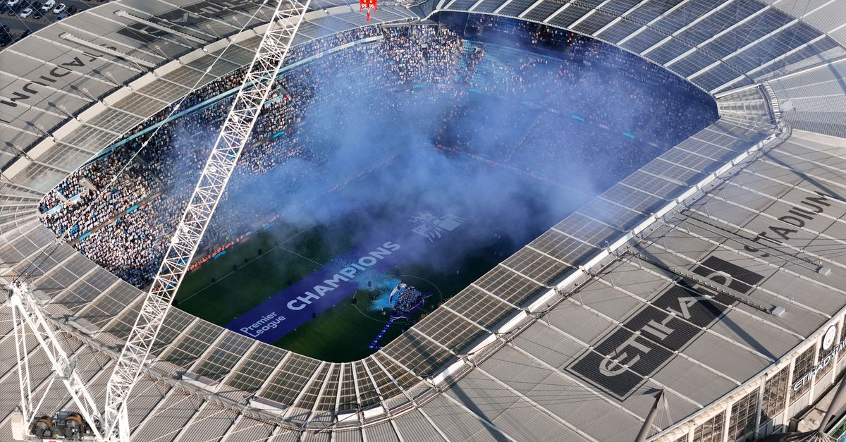 Aerial shot of Etihad Stadium during a soccer event in Manchester, UK.