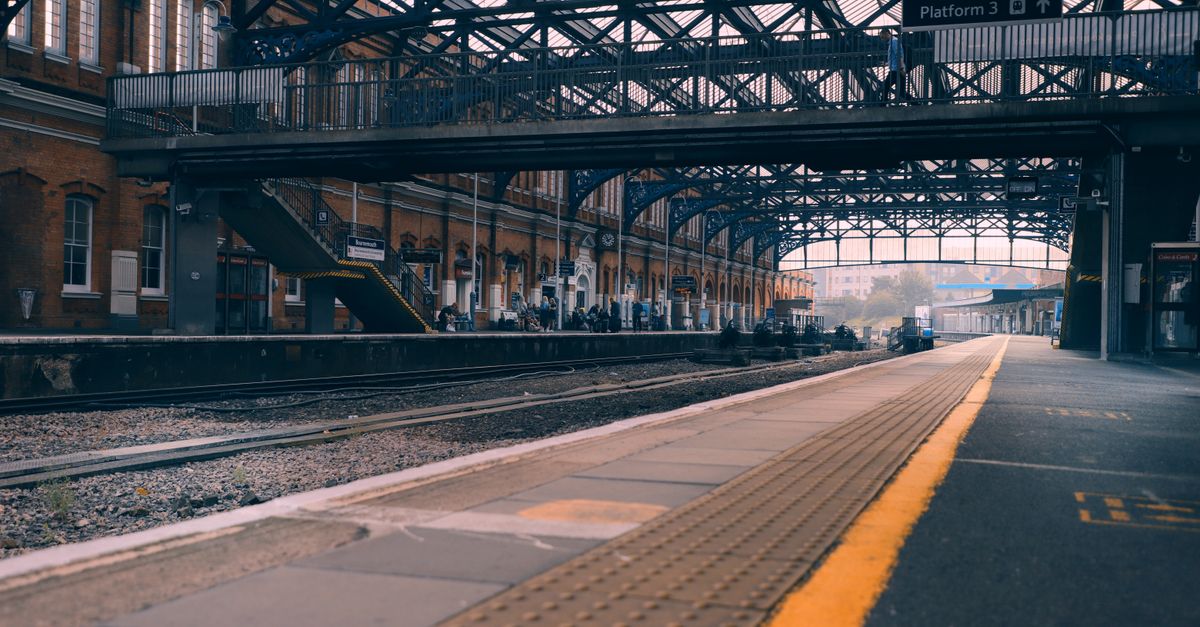 Bournemouth railway station showcasing its architecture and platforms in a tranquil early morning scene.