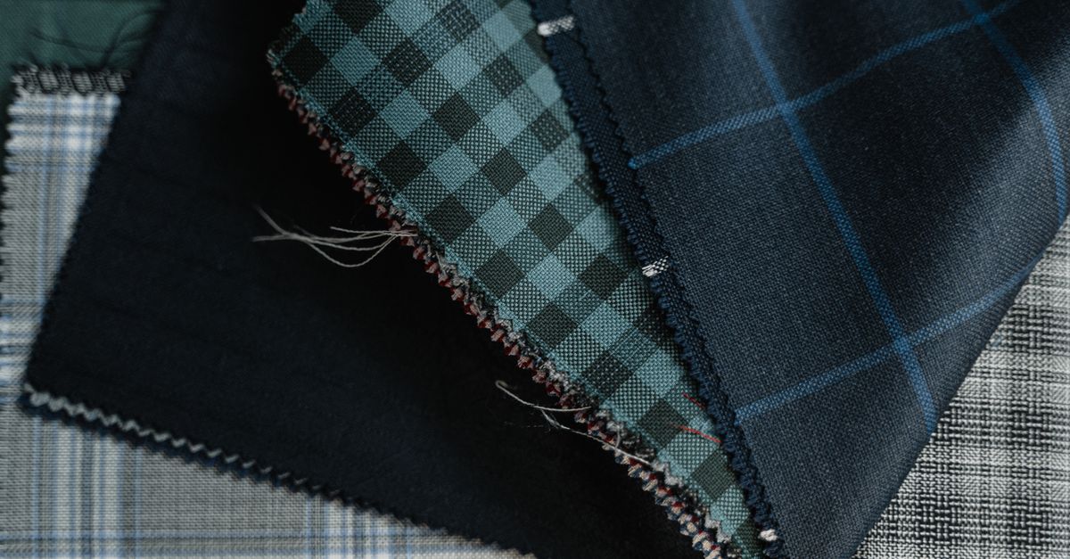 Detailed close-up of assorted plaid and checkered fabrics, showcasing textile textures and patterns.